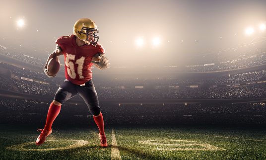 American football player in action on a professional stadium