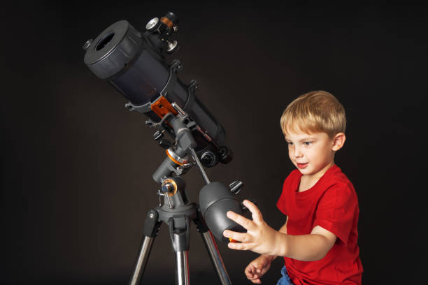 istock A little boy himself adjusts a large telescope. 1184614700