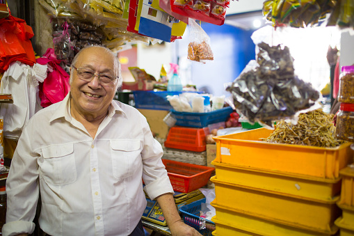 stall owner daily working in his own stall, looking at camera smiling
