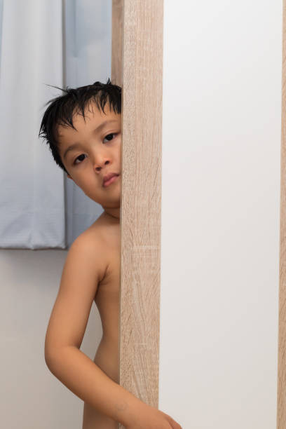 istock young boy naked and posing in his room 1184617294