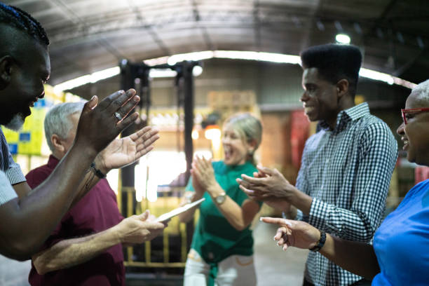 istock Happy employees celebrating together at warehouse 1184617591