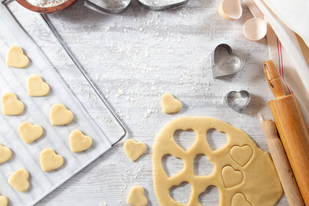 istock Making of Heart Shaped Cookies on White Kitchen Table 1184618270