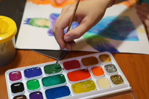 istock Artist with palette and brushes on white background 1184620104
