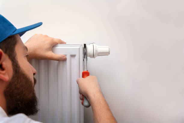 istock Repairman Fixing Radiator With Wrench 1184620586