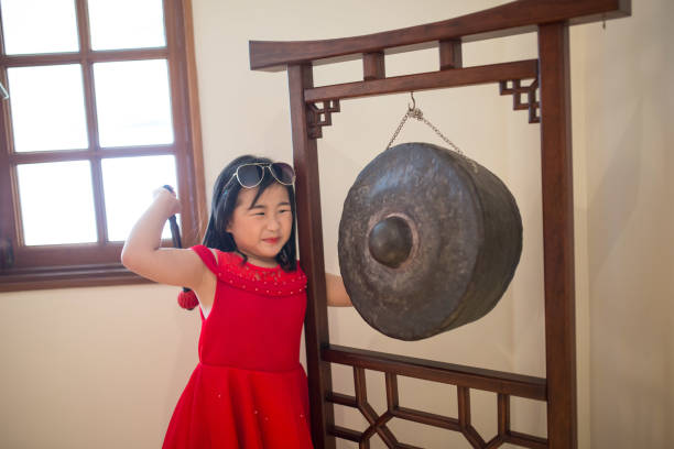 The girl is knocking Gong