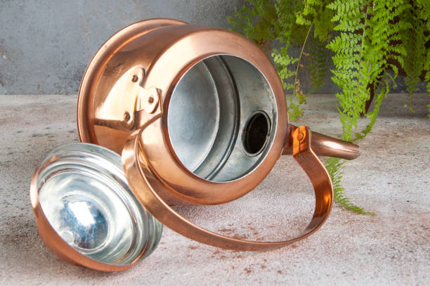 istock Antique copper kettle on concrete background. 1184625795