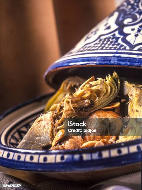 Closeup Of Moroccan Tajine With Chicken Artichoke And Nuts Stock Photo - Download Image Now