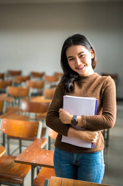 istock Female students pose in a university classroom 1184630272