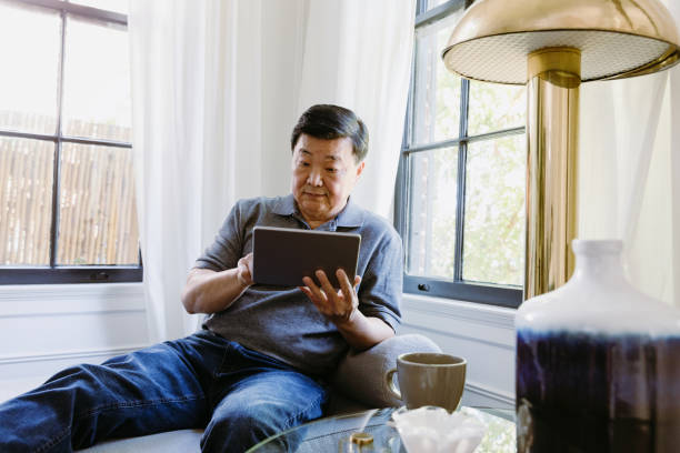 istock Serious man uses tablet at home 1184631075