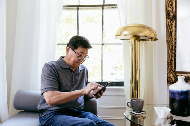 istock Senior man uses app on smartphone 1184631080