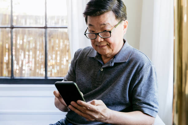 istock Senior man uses smartphone 1184631084