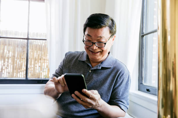istock Senior man uses app on smartphone 1184631101