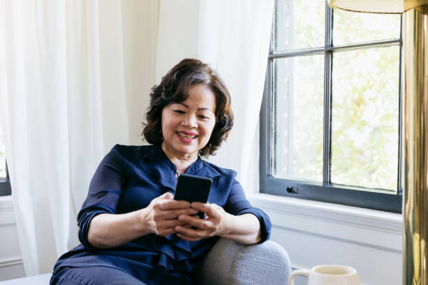 istock Beautiful senior woman using smartphone 1184631103