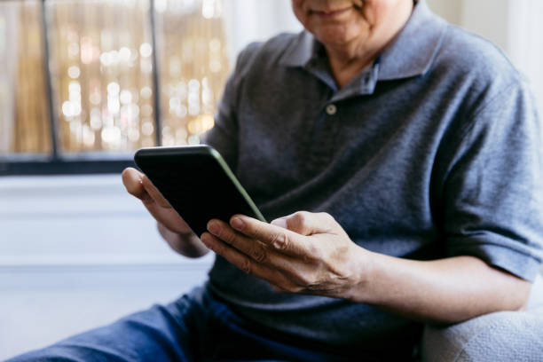 istock Senior man uses mobile app on smartphone 1184631111