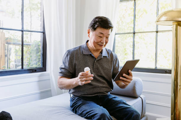 istock Senior man uses digital tablet at home 1184631136