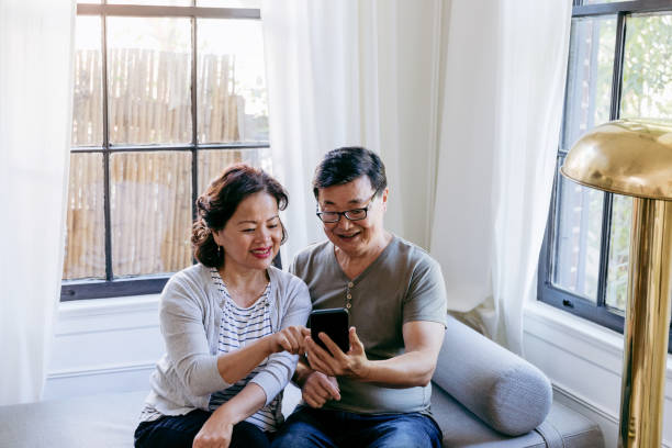 istock Senior couple use mobile app together 1184631144