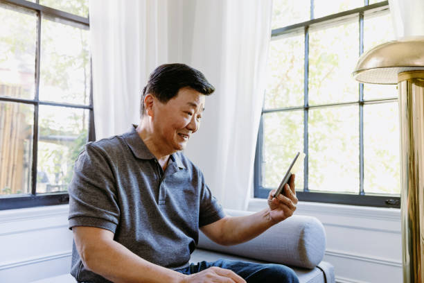 istock Cheerful man video chats with family 1184631159