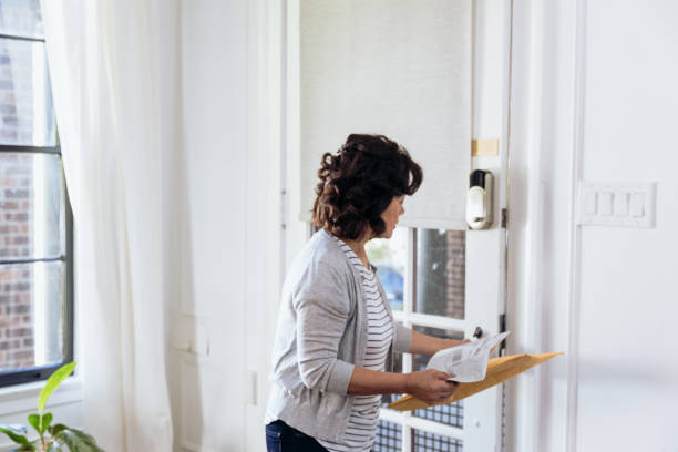 istock Senior woman picks up package from outside 1184631230