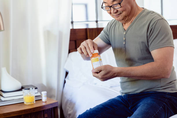 istock Senior man opens prescription medication 1184631259