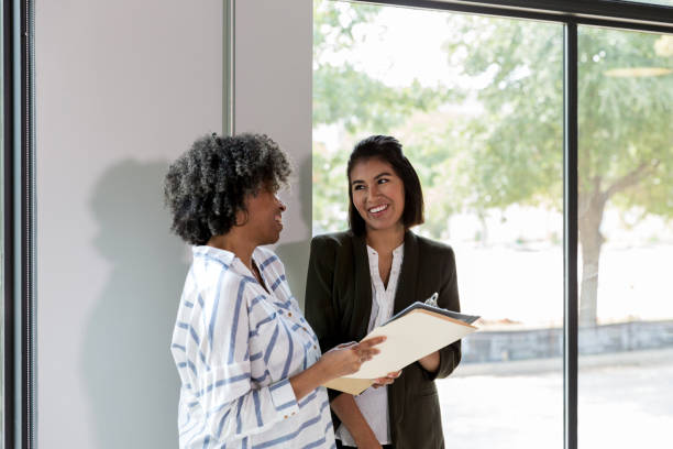 istock Two female employees have quick meeting 1184631435