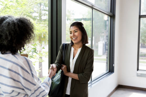 istock At end of interview, mature woman shakes hands with interviewee 1184631443