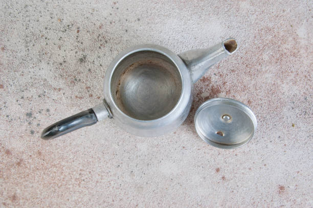 istock Silver metal tea pot on concrete background. 1184632473