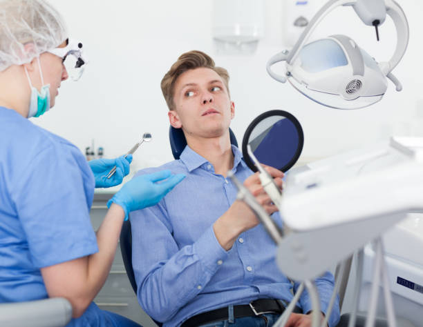 istock Dentist shows the patient in the mirror problems with teeth 1184634856