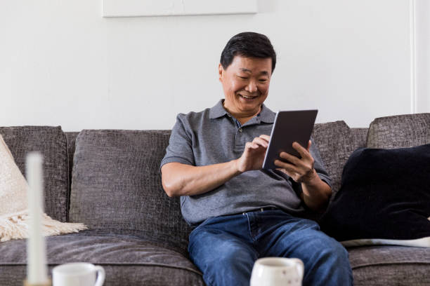 istock Senior man uses mobile app on digital tablet 1184637902