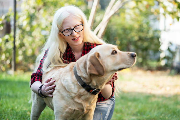 istock Albino girl with her dog 1184638212
