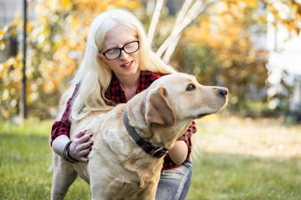 istock Albino girl with her dog 1184638247