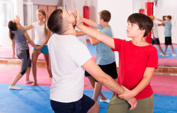 istock Kids exercising self-defense movements 1184638440