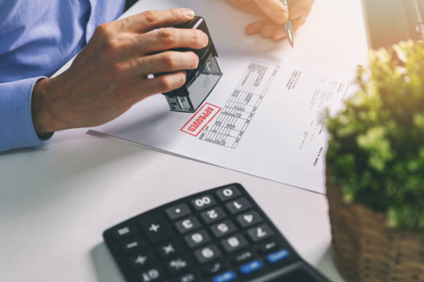 istock businessman accepting and stamping procurement bill in office 1184638601