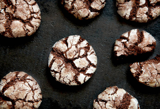 istock Chocolate Crinkles. Chocolate cookies in powdered sugar on a dark background 1184640183