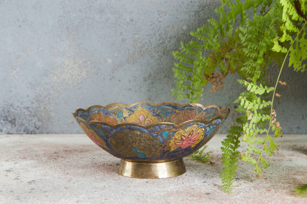 istock Old brass bowl and green plant 1184640358
