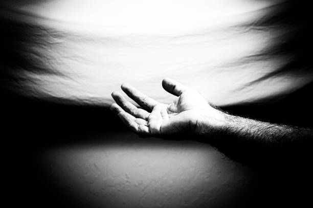 istock high contrast arm reaching out palm up 1184640690