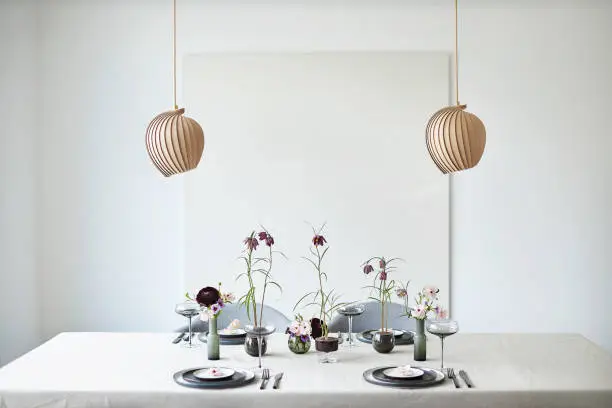 A minimalist table decoration with fritillaria and anemones flowers