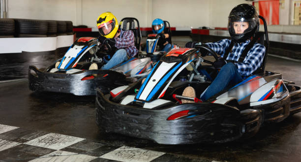 istock Group of people driving go-carts at racing track 1184641008