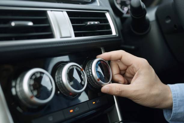 Men are turning on car air conditioning systems.