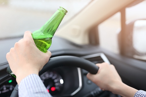 Men are drinking beer with alcohol while driving