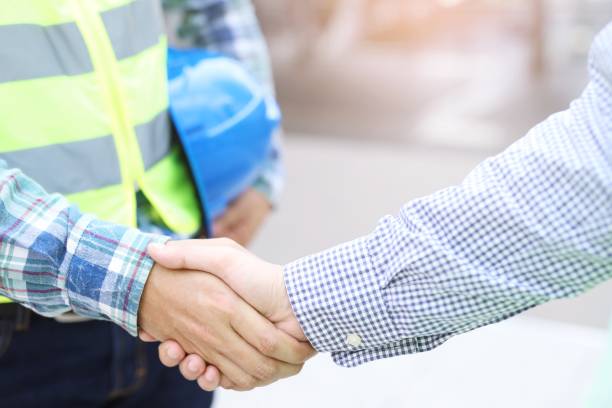 istock Businessmen join hands to coordinate the work. 1184642478