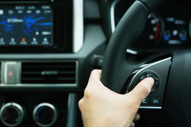 istock The concept of using hands to press the volume control switch in the car 1184642633
