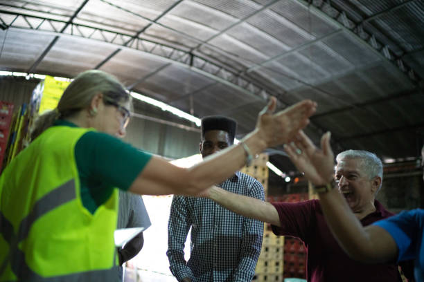 istock Happy employees celebrating together at warehouse 1184644715