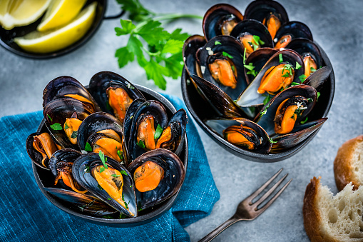 Steamed mussels on blue background