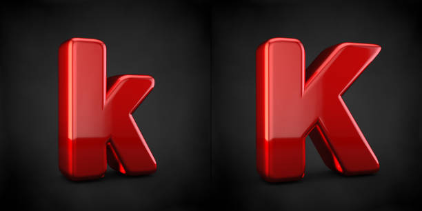 Red letter K isolated on black background. 3d red glossy alphabet font.