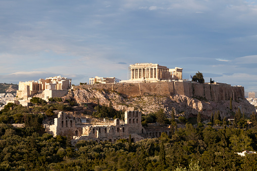 Aerial view of theskyline and ancient ruins at the Acropolis of Athens, Greece, and Odeon of Herode theatre during sunset time