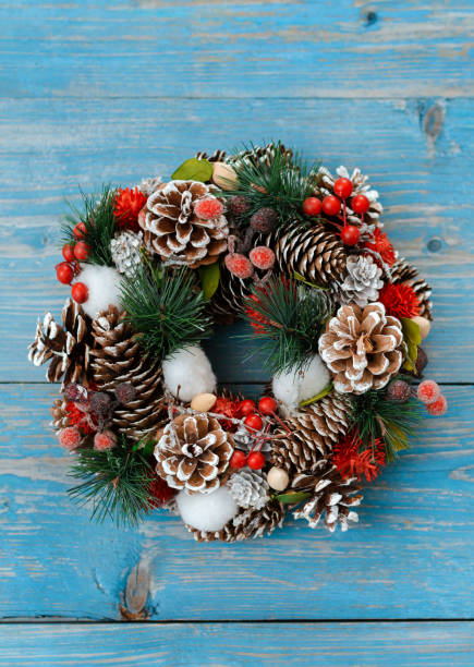 istock Christmas tree branches with cones on a dark wooden Board against a gray concrete wall. 1184649207