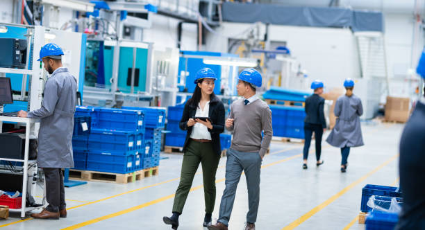 istock Mechanical Engineer Talking To Female Manager In A Factory 1184649881