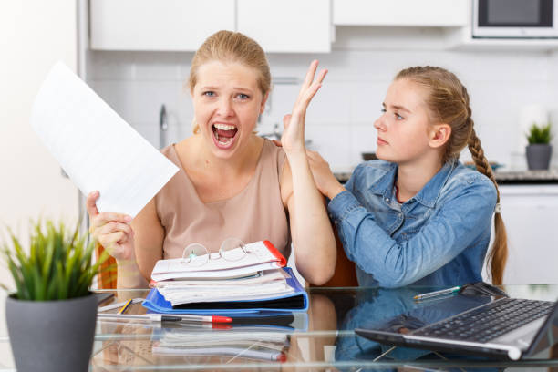 istock Mother scolds daughter for poor grades 1184650474