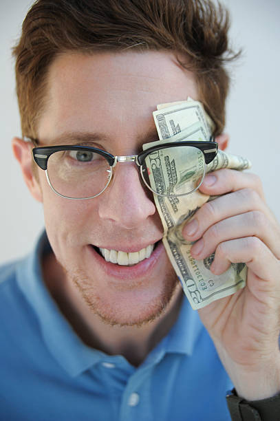 istock Happy, Smart, greedy Nerd looking at camera, Holding Money 118465178
