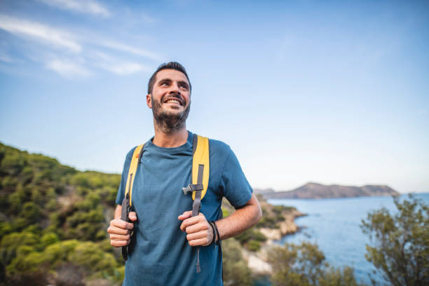 istock Smiling Young Male Backpacker Enjoying Late Summer Hike 1184651809